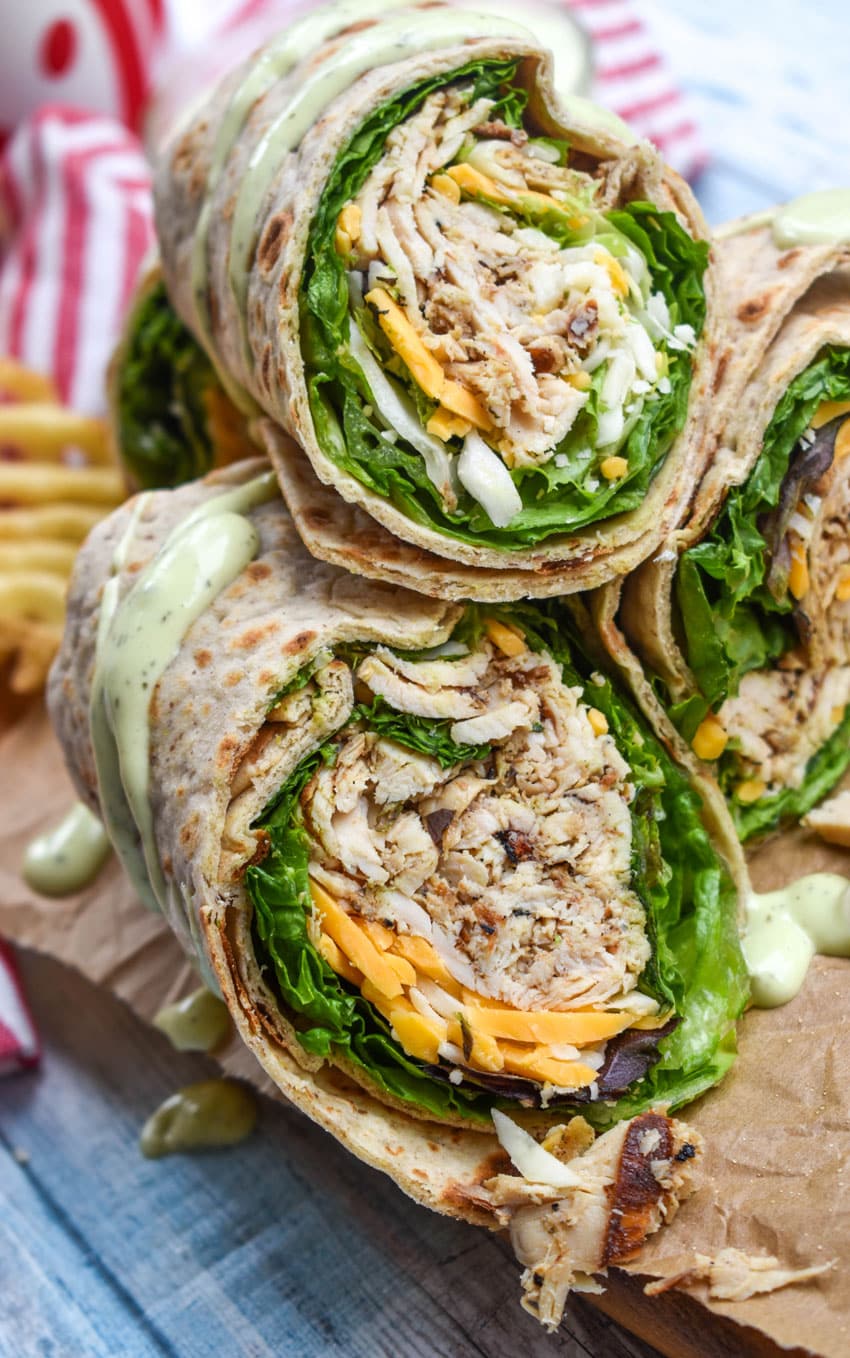 chick fil a chicken cool wraps cut in half and stacked on brown parchment paper