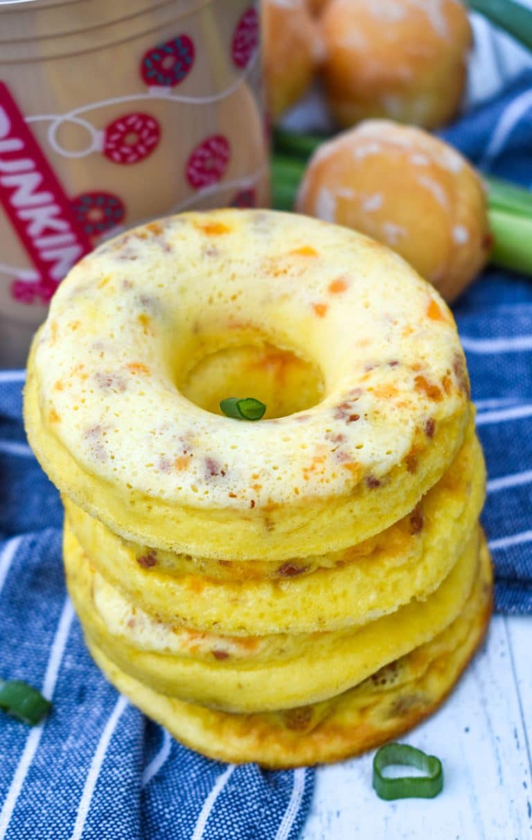 a stack of copycat dunkin donut omelet bites with a plastic cup of coffee in the background