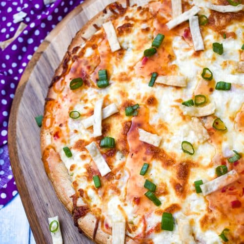 a crab rangoon pizza on a wooden pizza peel