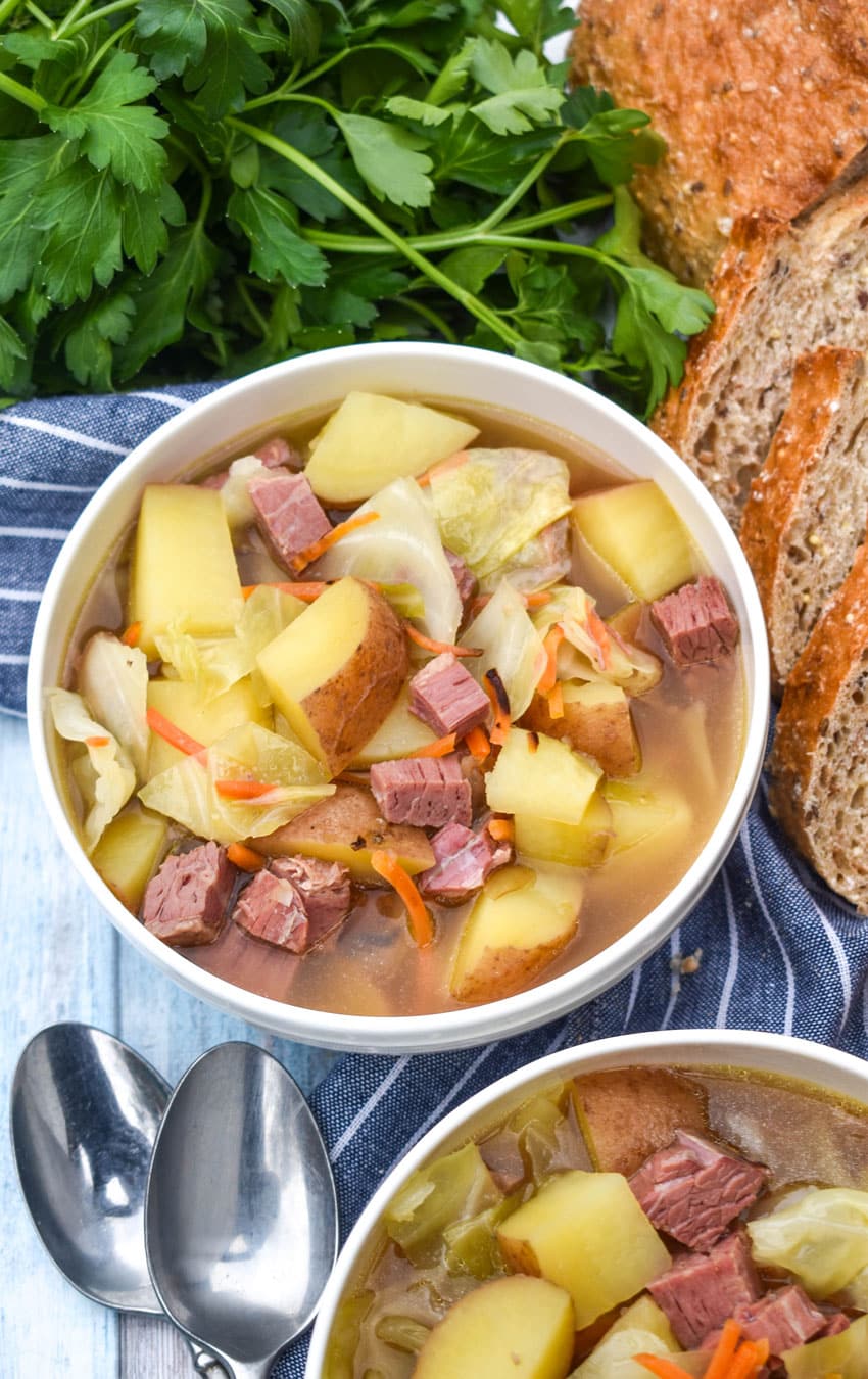 corned beef and cabbage soup in two white bowls