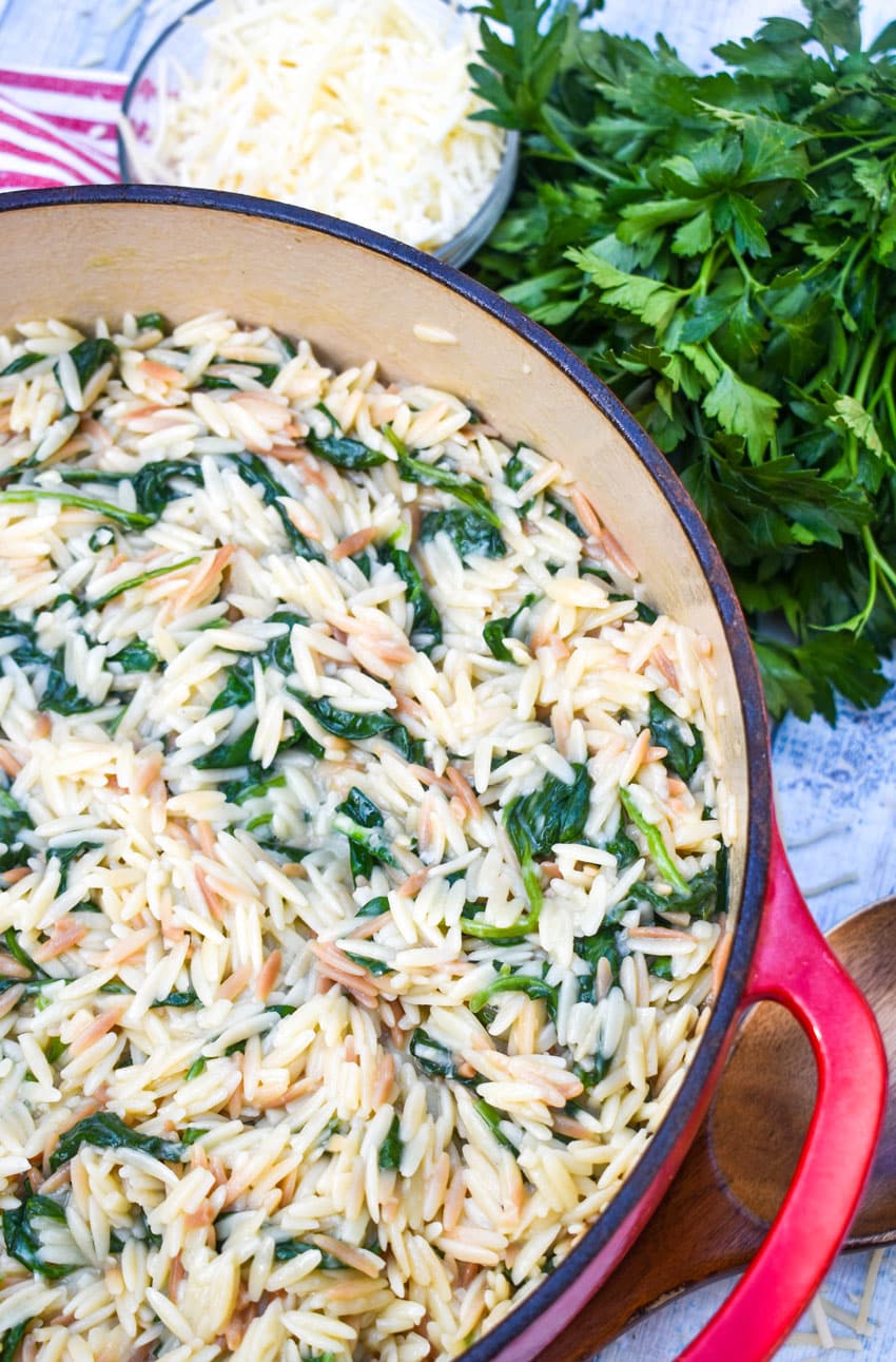 spinach parmesan orzo in a large red dutch oven