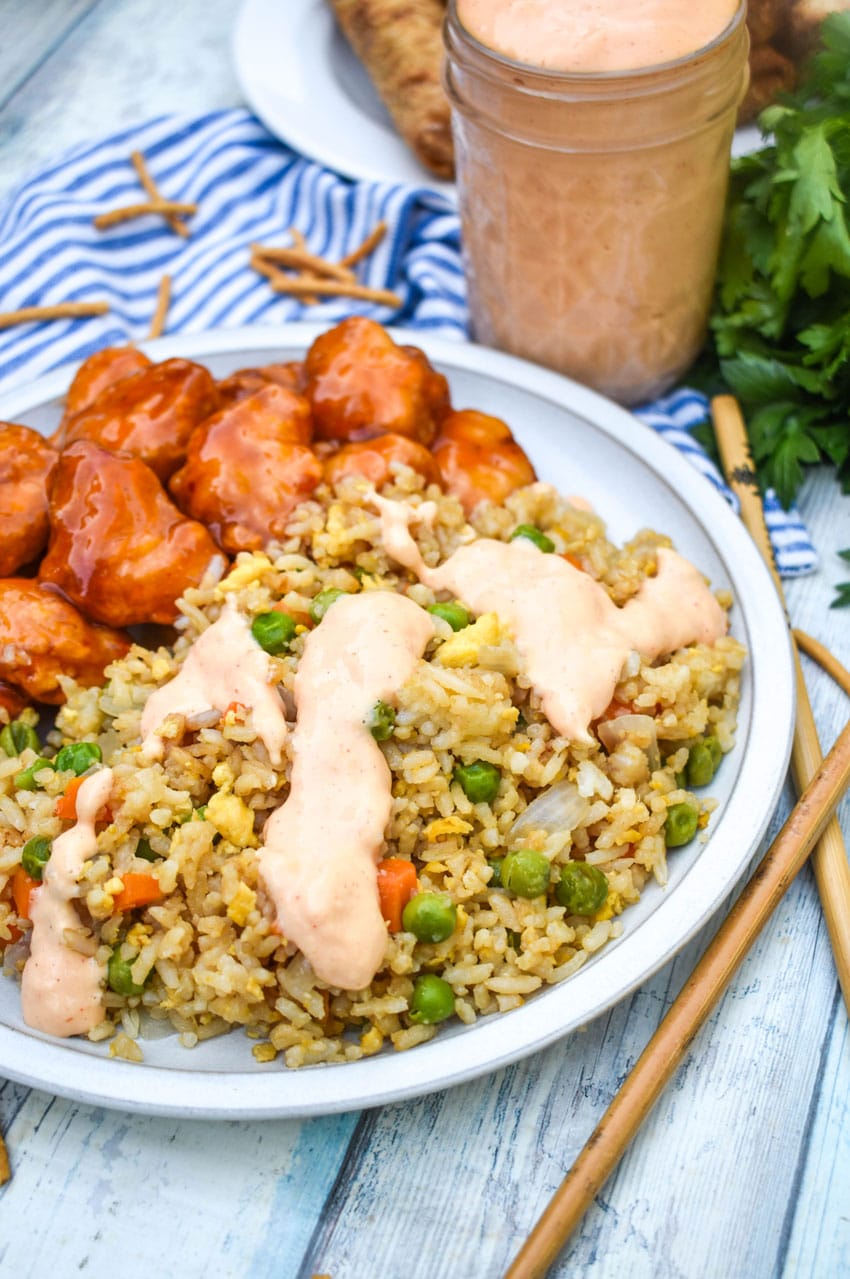 homemade yum yum sauce on fried rice on a small gray plate