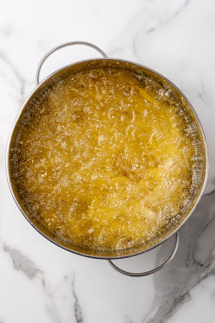 fresh cut fried cooking in a pot of hot oil