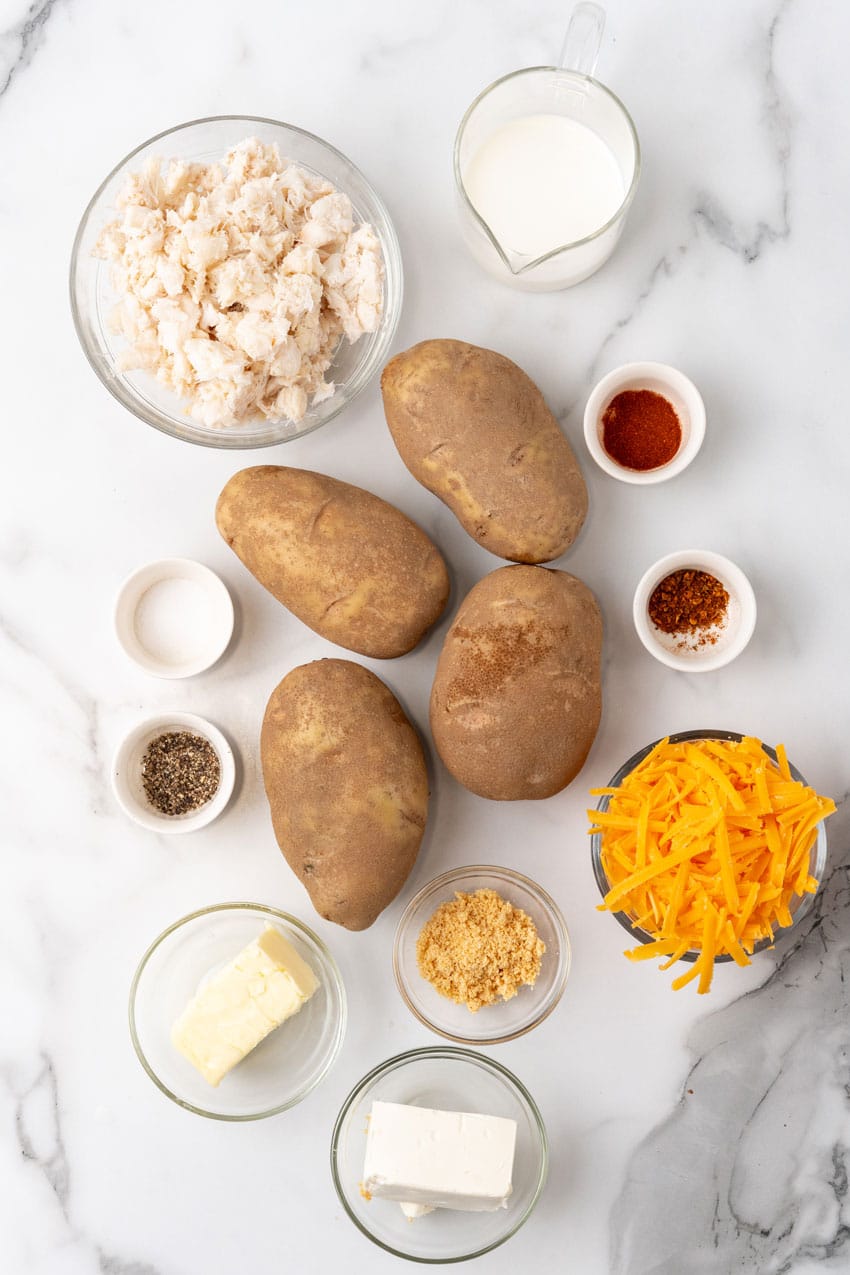 an overhead image showing the measured ingredients needed to make twice baked crab stuffed potatoes