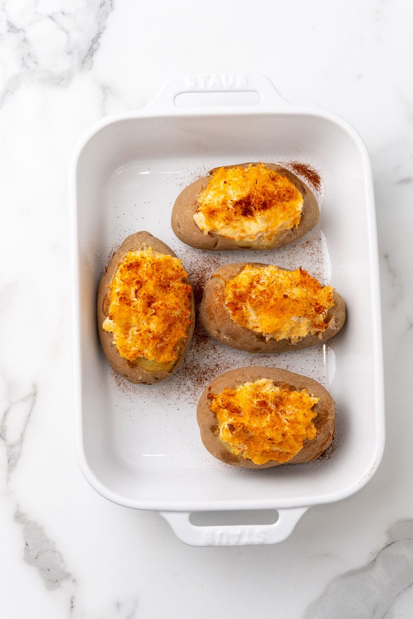 twice baked crab stuffed potatoes in a small white baking dish