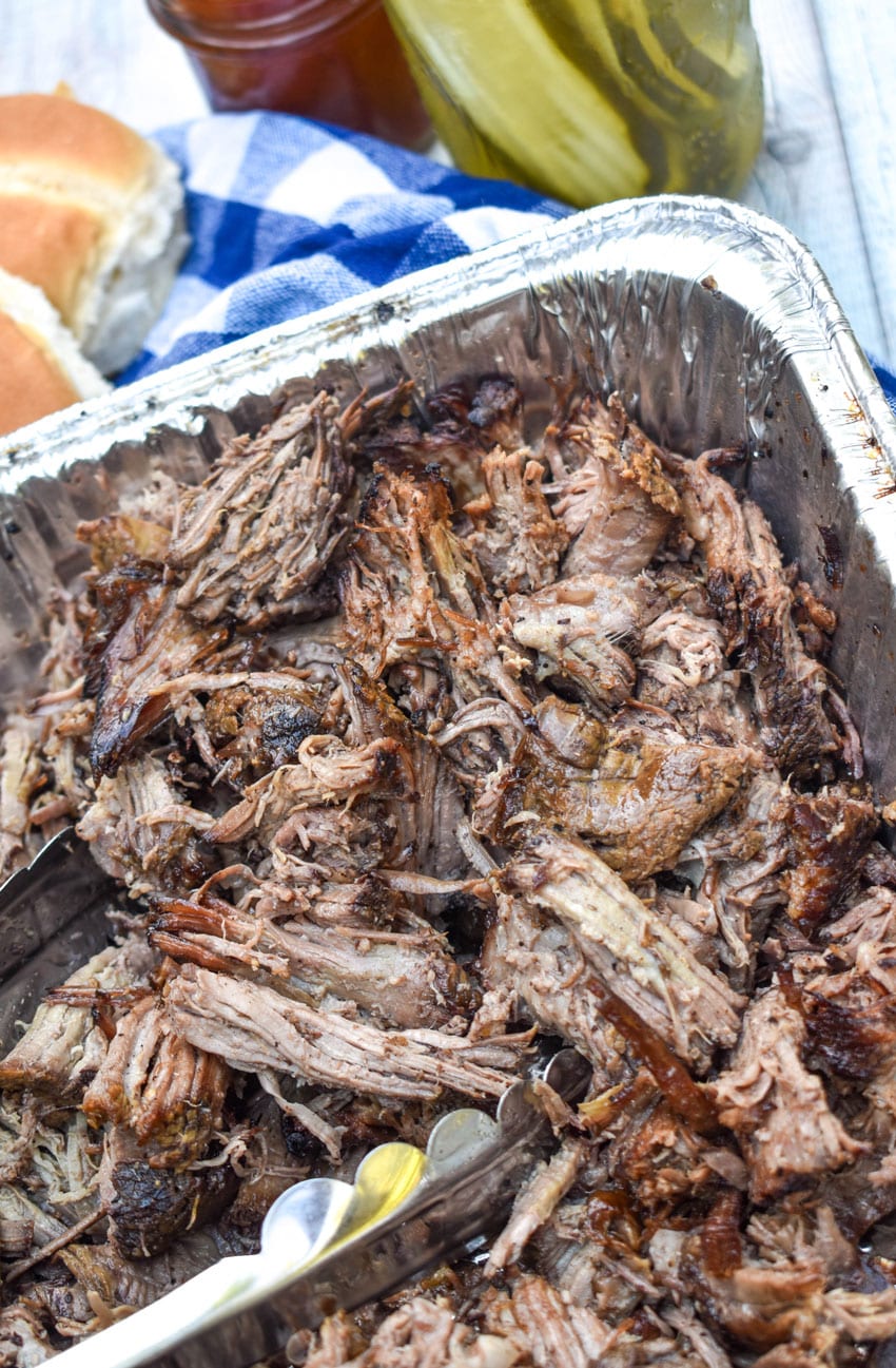 shredded smoked chuck roast in an aluminum pan