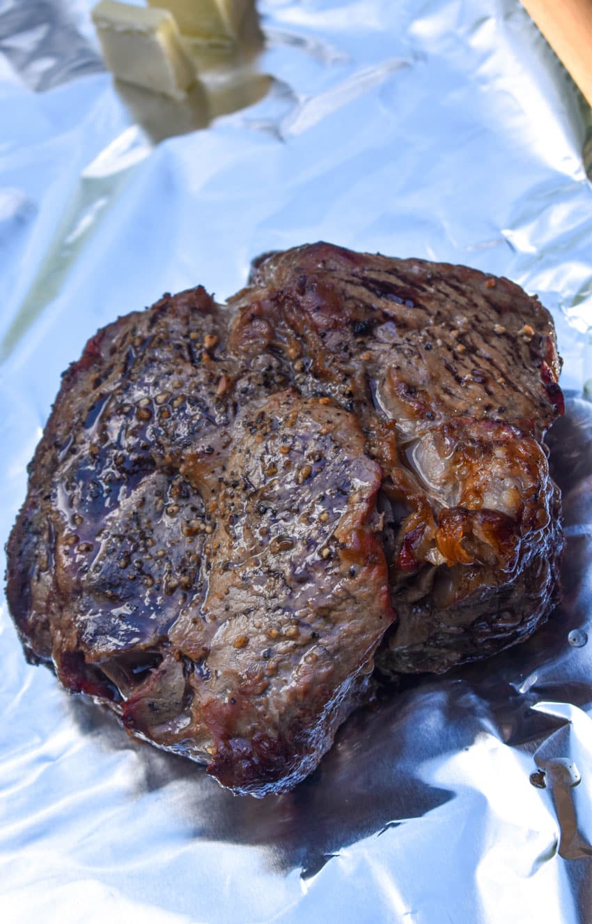 a seared chuck roast resting on a sheet of aluminum foil