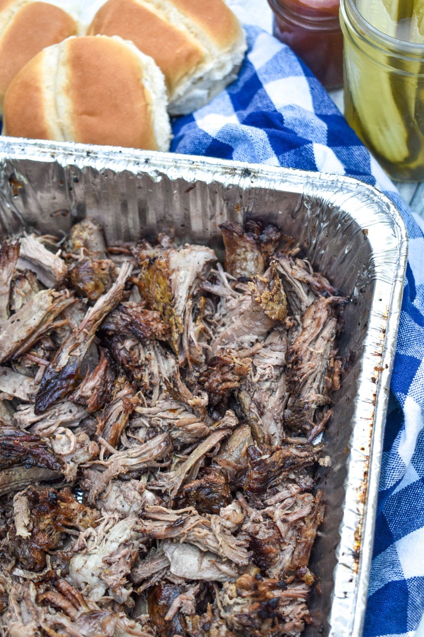 shredded smoked chuck roast in an aluminum pan