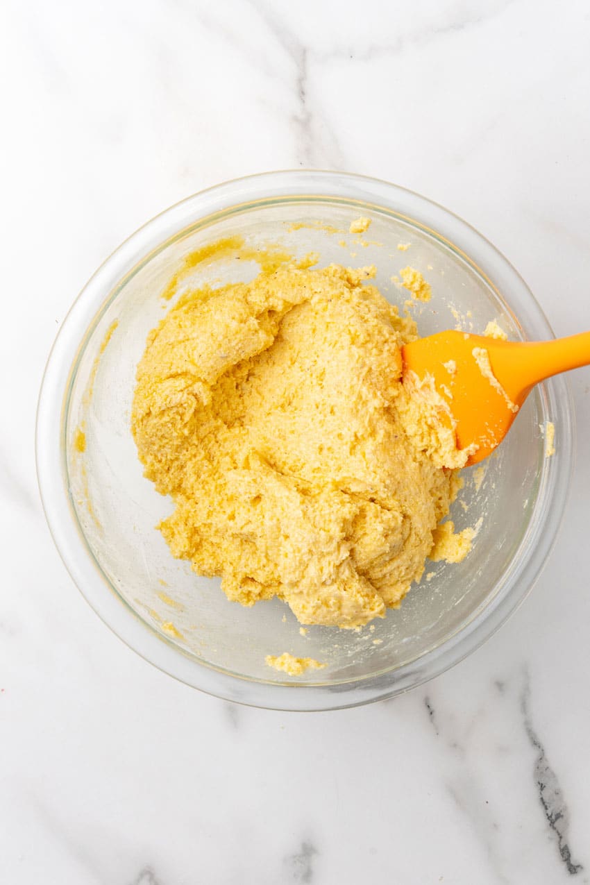 air fryer hush puppy batter in a clear glass mixing bowl