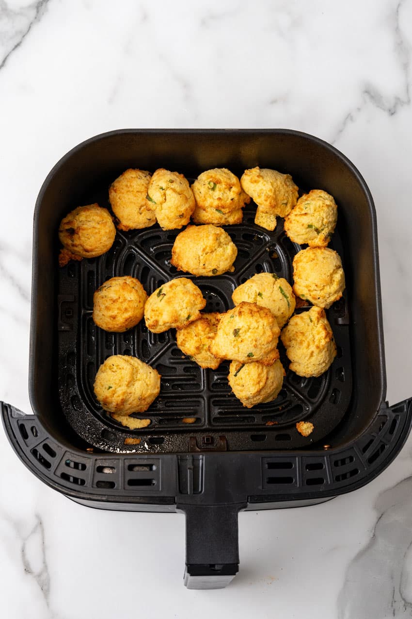 cooked air fryer hushpuppies in the basket of an air fryer