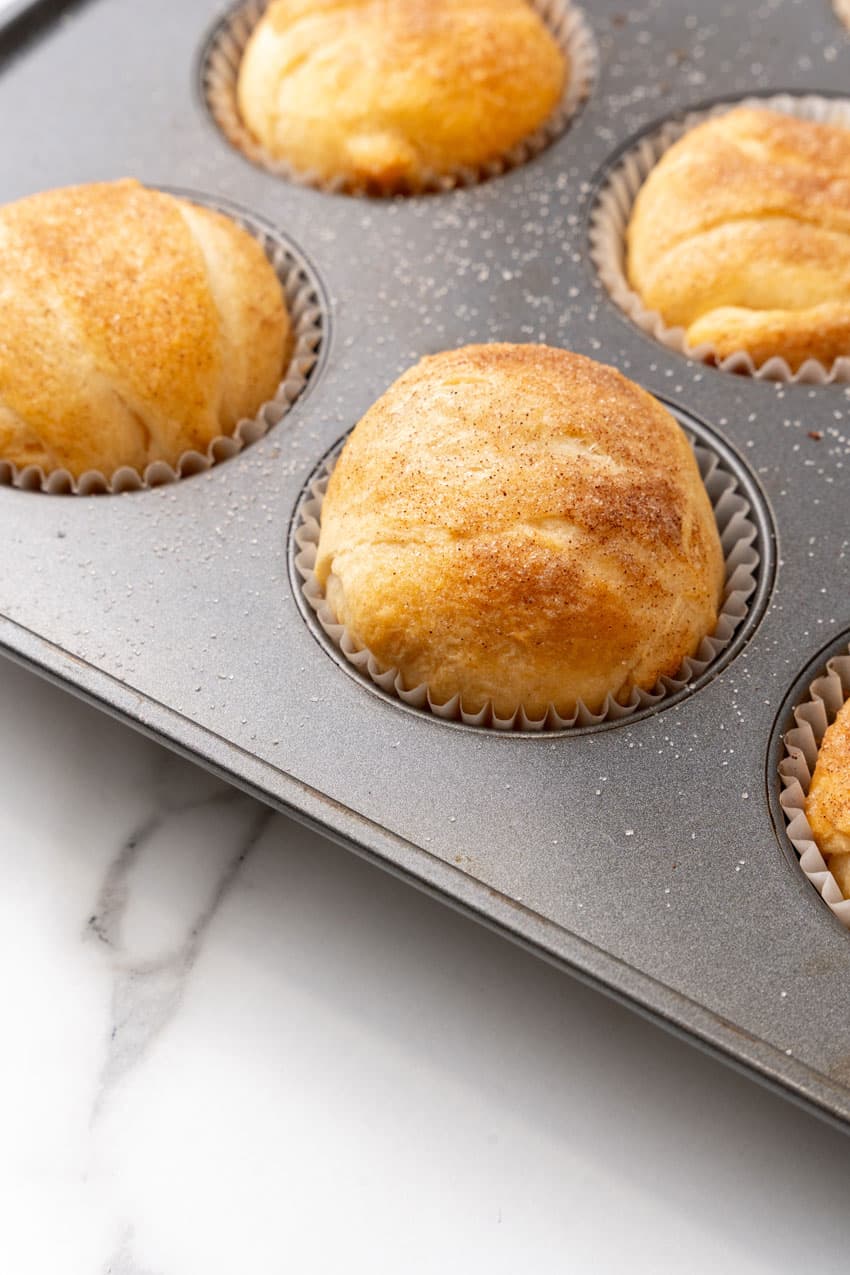 baked puffed up resurrection rolls in a metal muffin pan