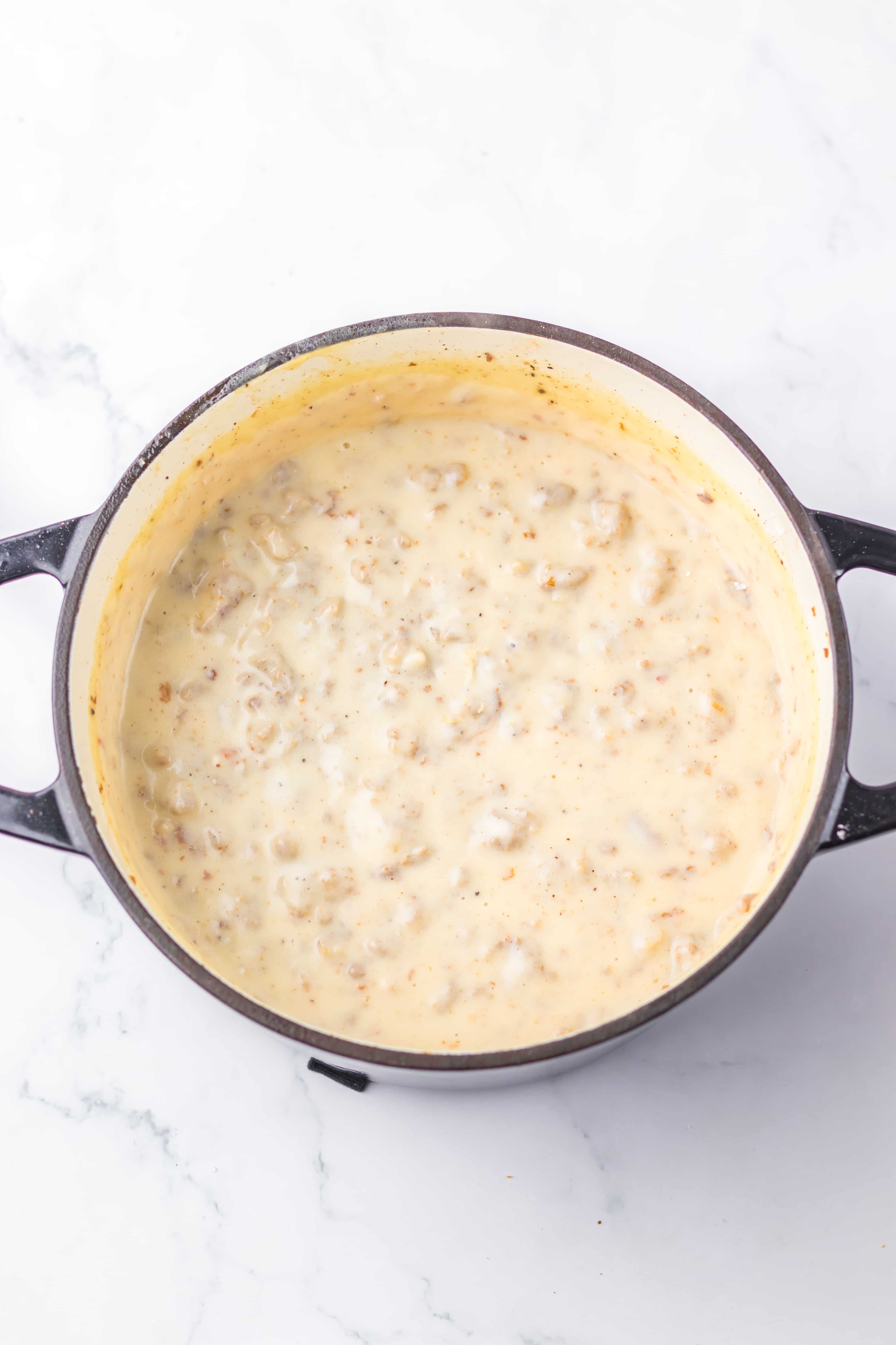 homemade cracker barrel sausage gravy in a small dutch oven