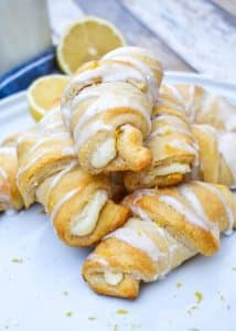 lemon cheesecake crescent rolls piled on a white dinner plate