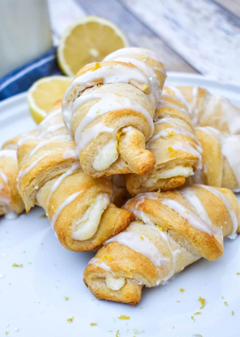 lemon cheesecake crescent rolls piled on a white dinner plate