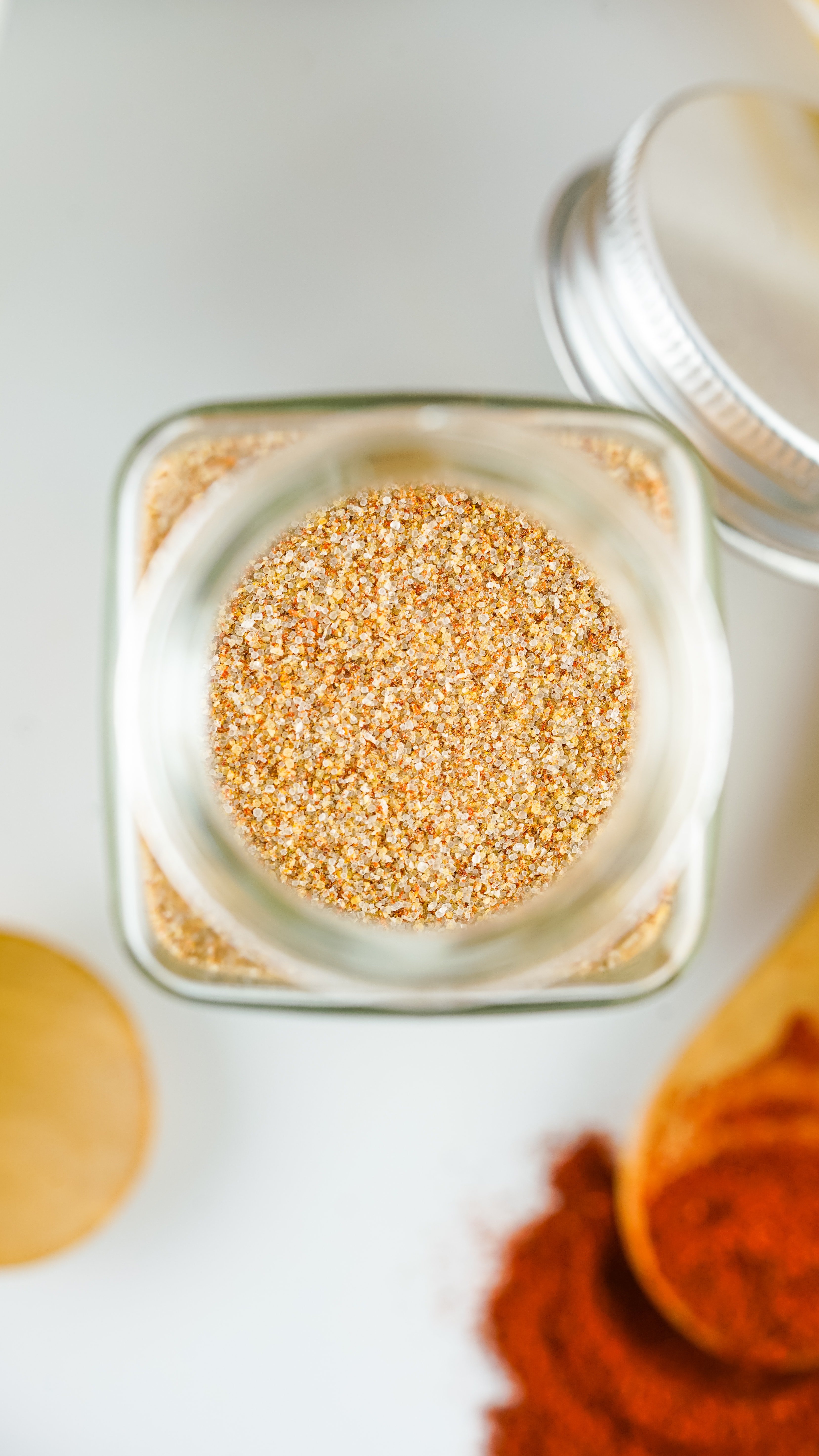 a close up of homemade seasoning salt in a small glass jar