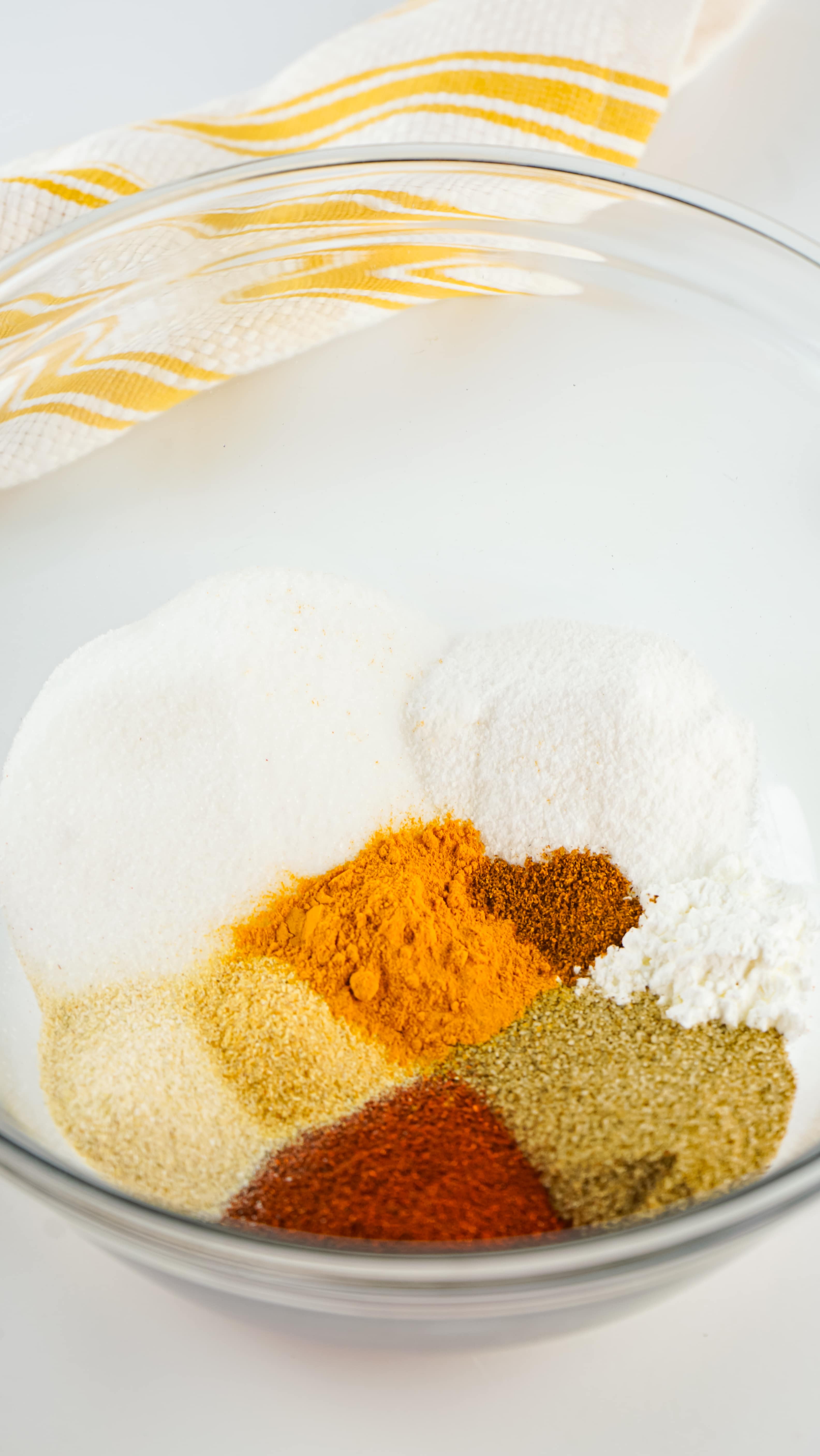 a variety of seasonings in a glass mixing bowl