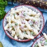 ruby tuesday's pasta salad copycat recipe in two small red bowls with fresh herbs in the background