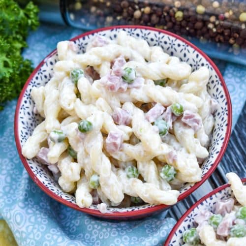 ruby tuesday's pasta salad copycat recipe in two small red bowls with fresh herbs in the background