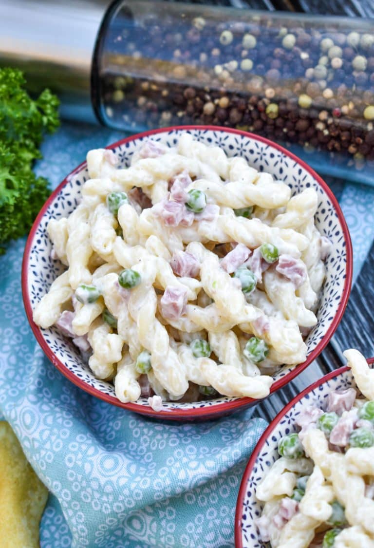 ruby tuesday's pasta salad copycat recipe in two small red bowls with fresh herbs in the background