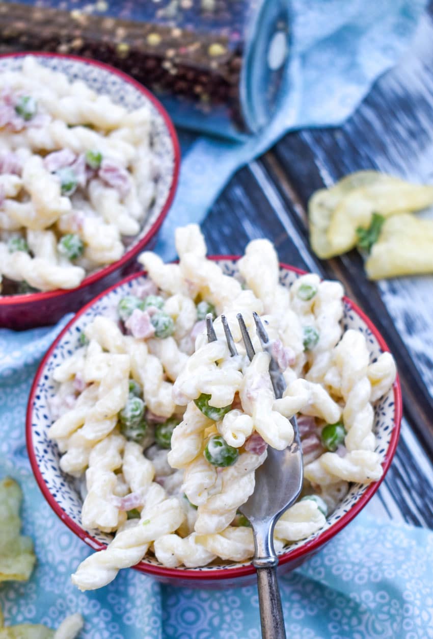 ruby tuesday's pasta salad copycat recipe in two small red bowls with fresh herbs in the background