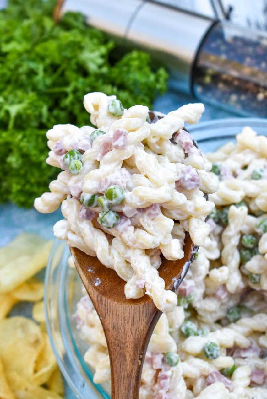a wooden spoon holding up a scoop of ruby tuesday's pasta salad
