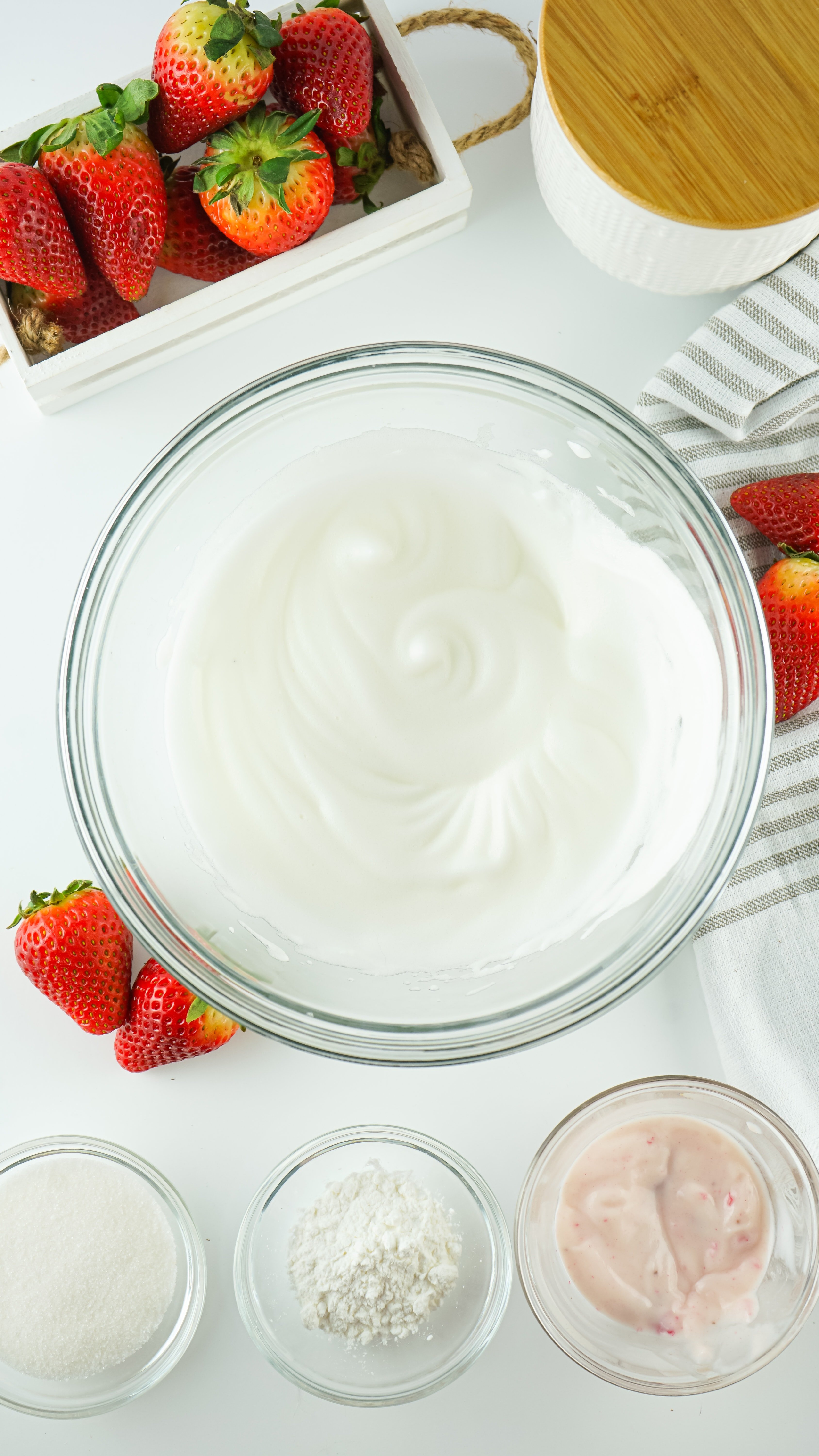 whipped meringue in a glass mixing bowl