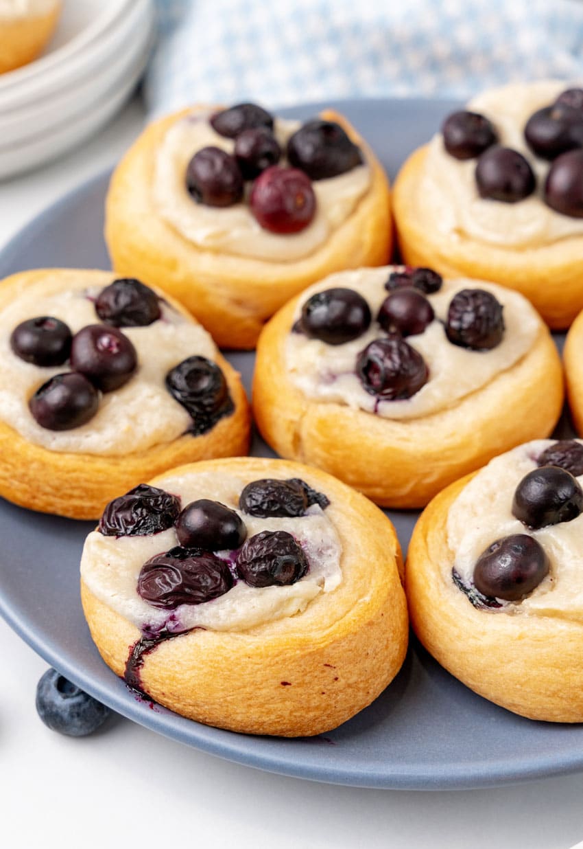 blueberry cream cheese danishes arranged on a blue plate