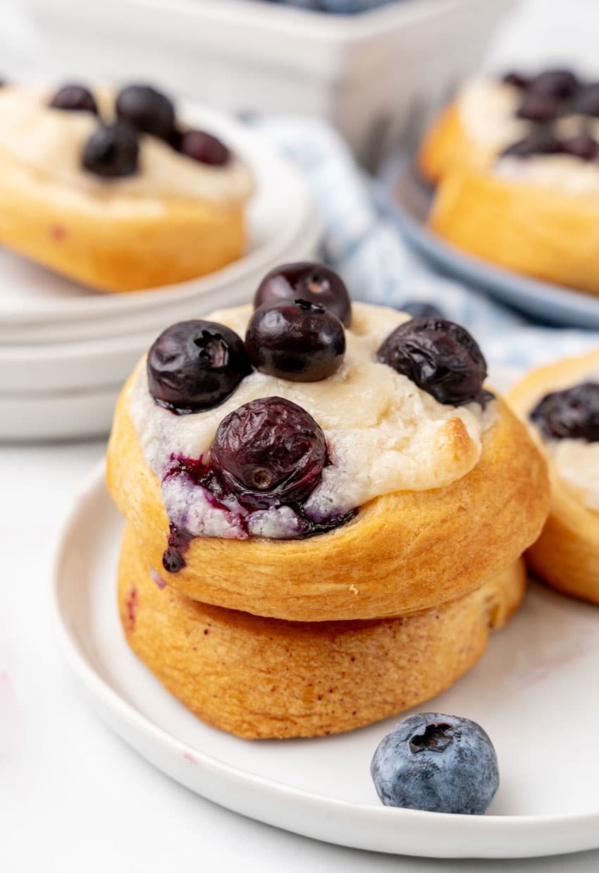 blueberry cream cheese danishes on a small white dessert plate
