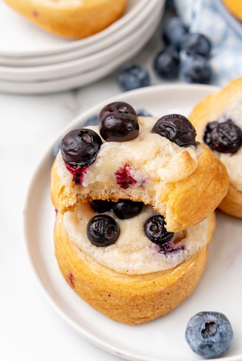 blueberry cream cheese danishes on a small white dessert plate