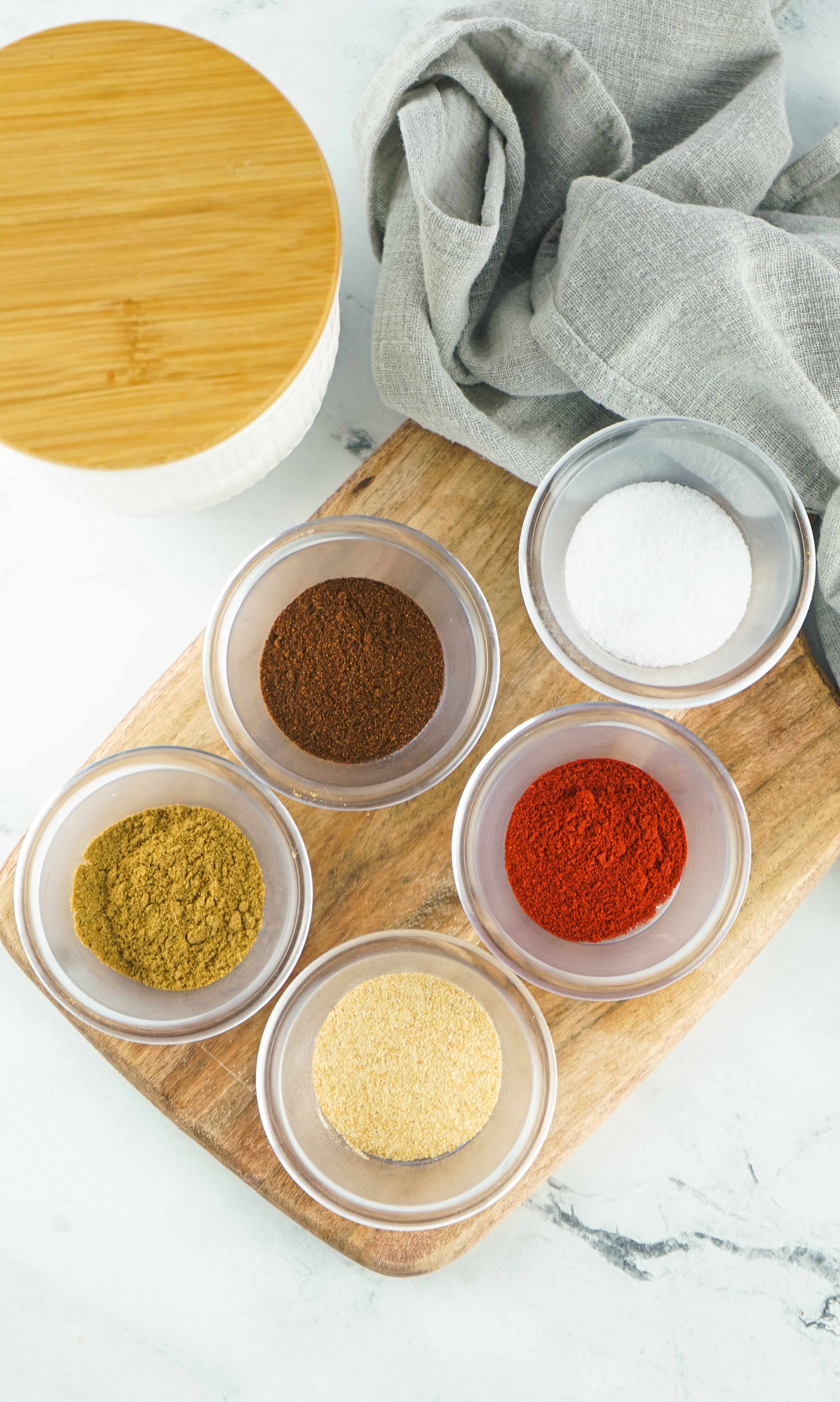 an overhead image showing the measured ingredients needed to make a batch of homemade fajita seasoning
