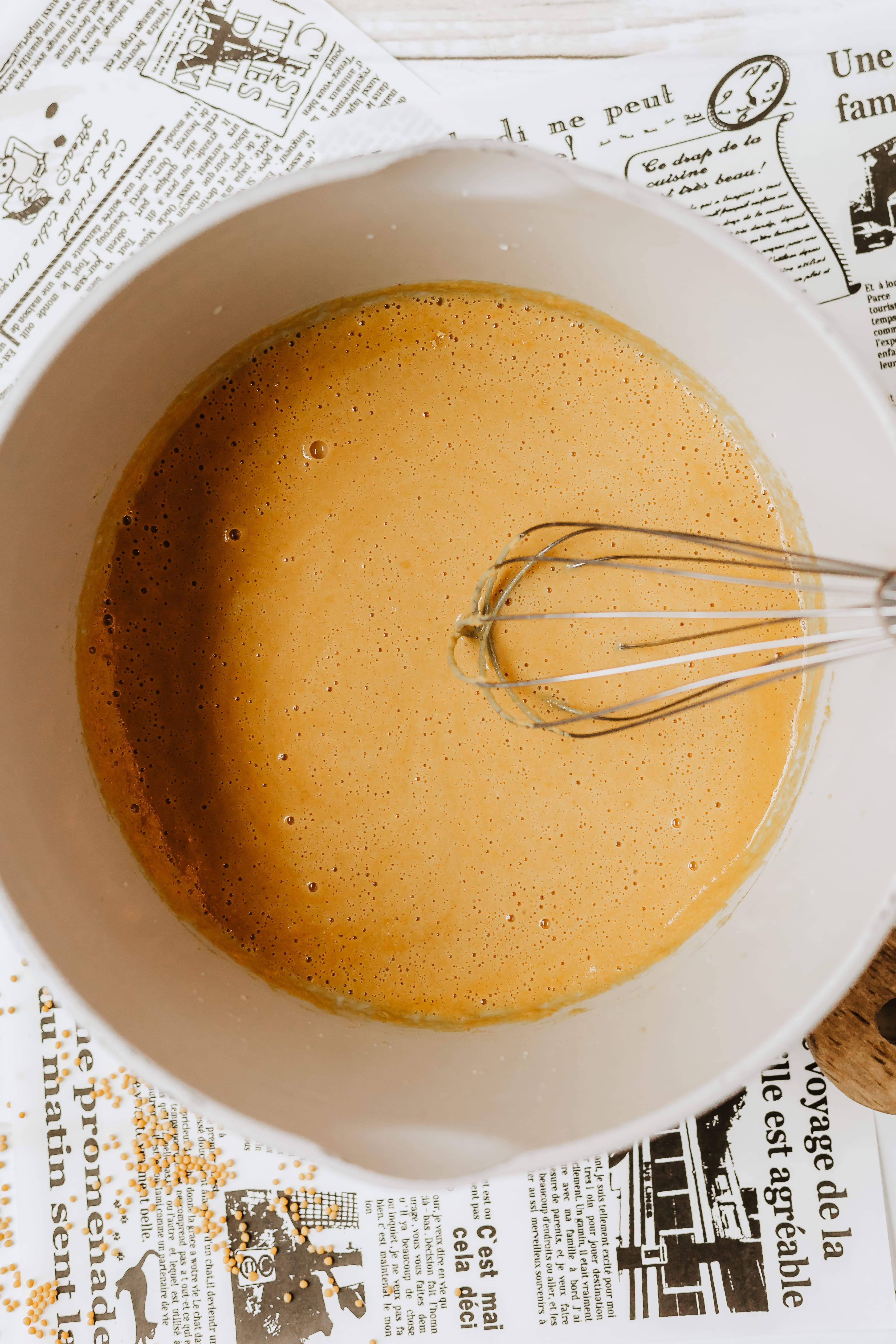 homemade yellow mustard in a white mixing bowl