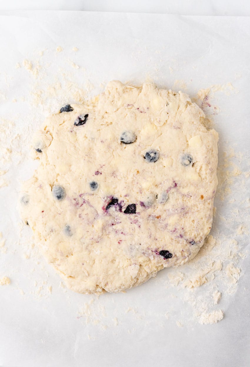 homemade bo berry biscuit dough on a floured counter top