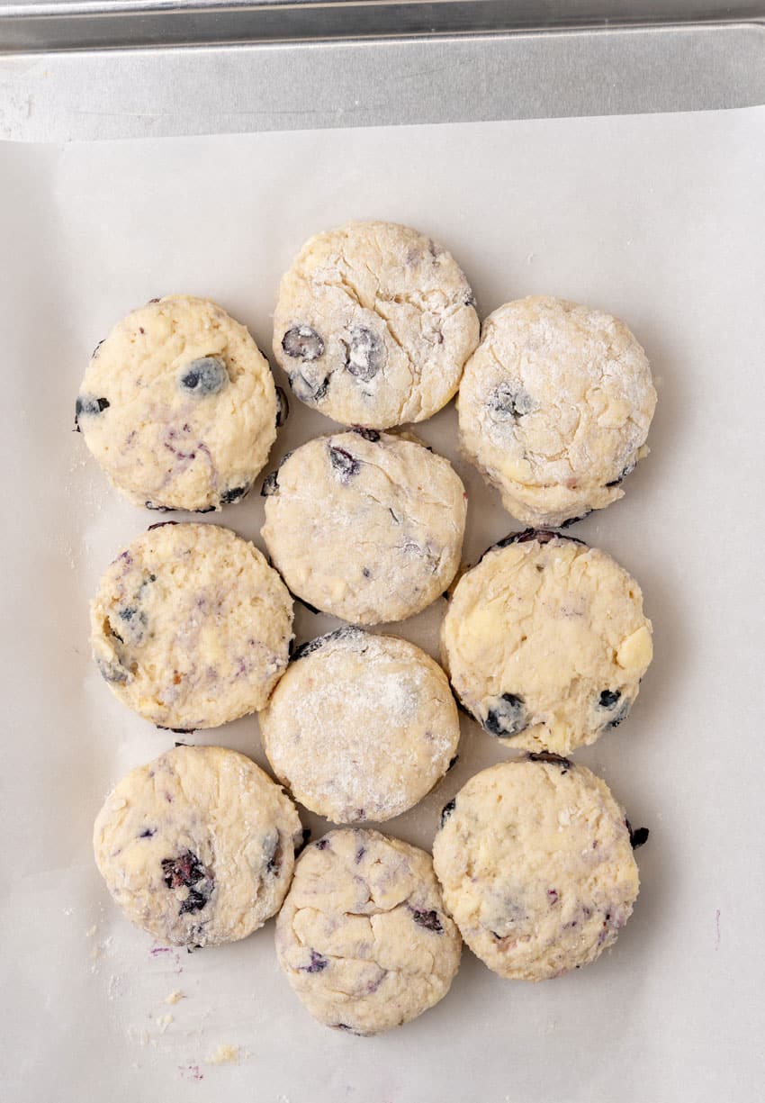 homemade boberry biscuits arranged on a parchment paper lined baking pan