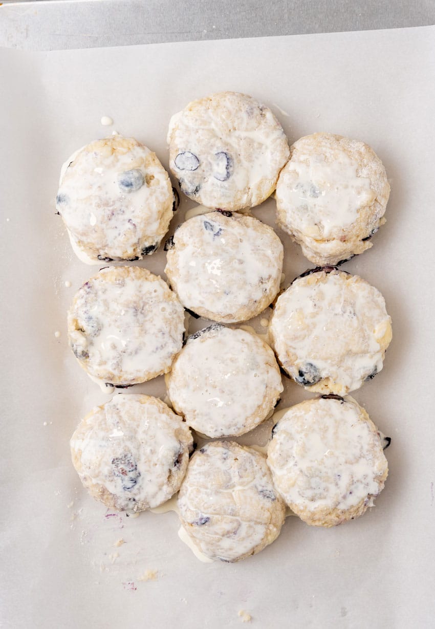 homemade boberry biscuits arranged on a parchment paper lined baking pan