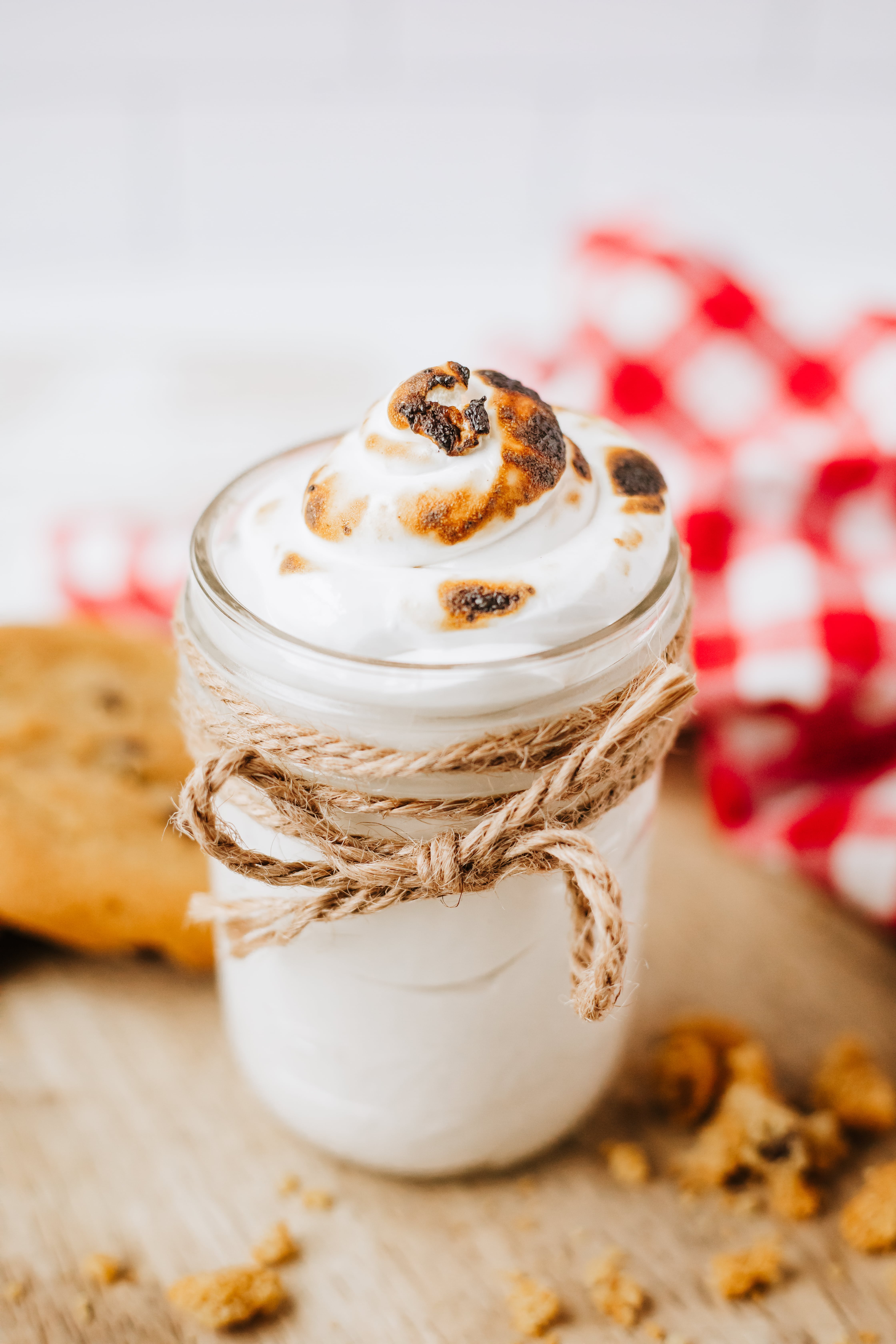 homemade marshmallow fluff in a glass jar on a wooden countertop