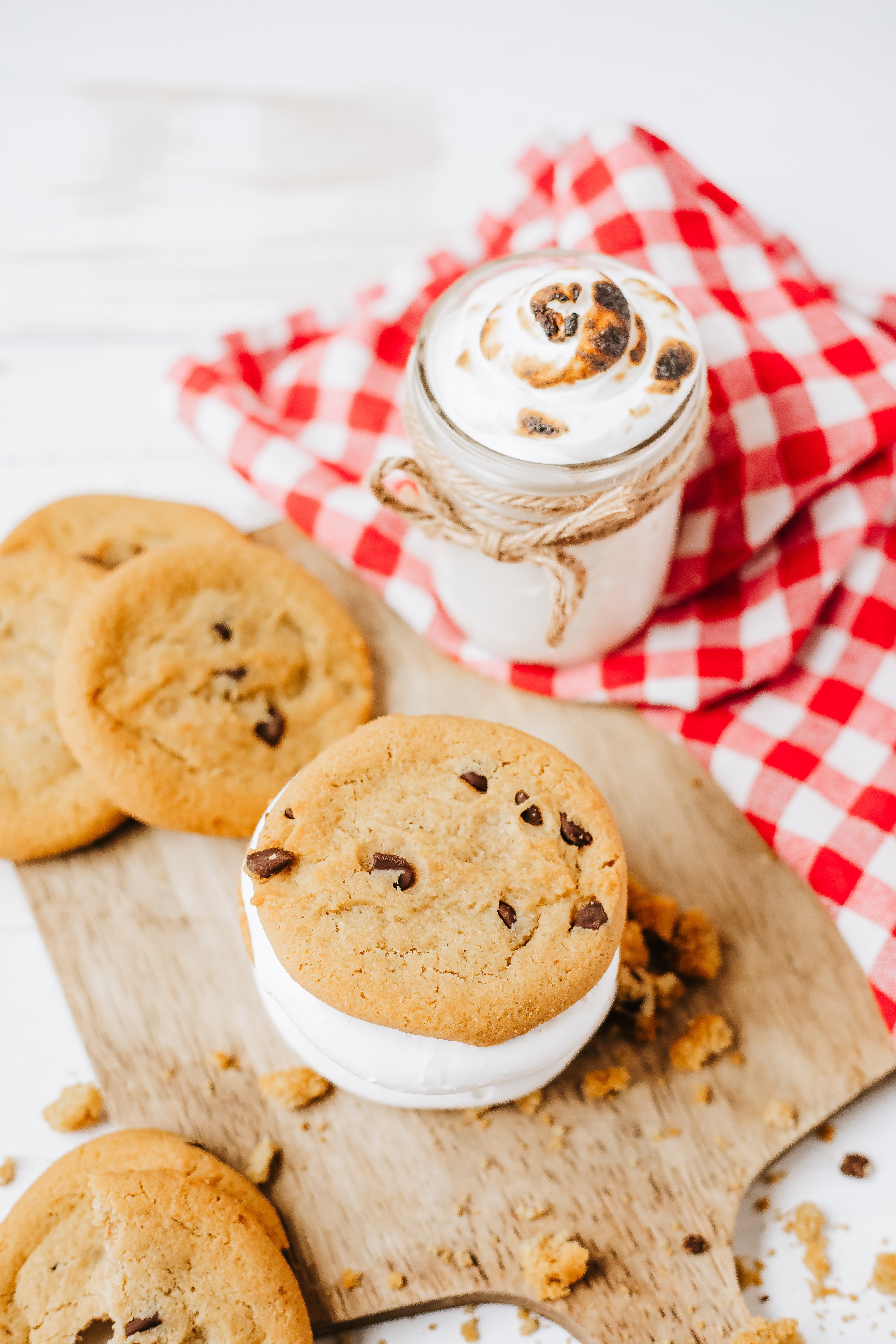 homemade marshmallow fluff in a glass jar on a wooden countertop