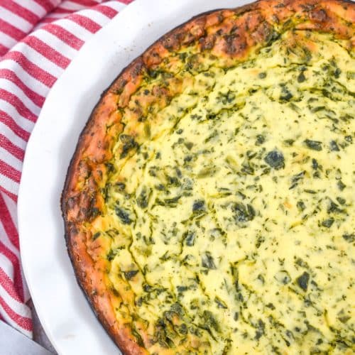baked spinach ricotta pie in a white pie dish