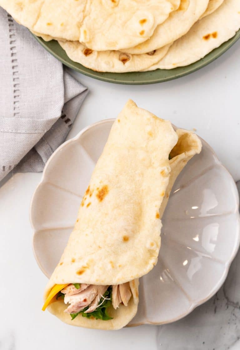 a chicken wrap on a small white plate