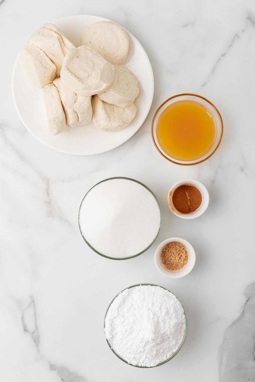 an overhead image showing the measured ingredients needed to make a batch of easy apple cider glazed donuts