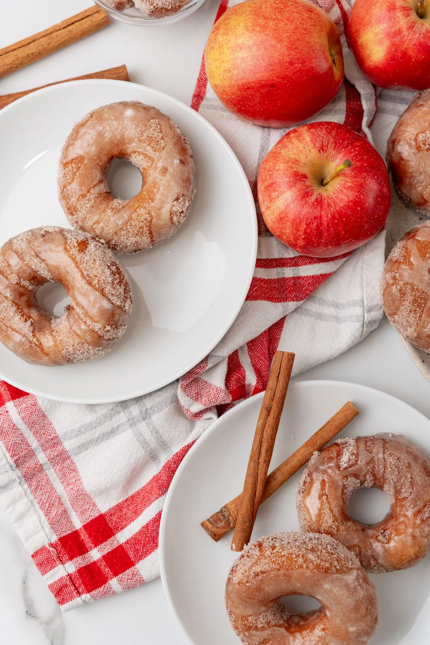 glazed apple cider donuts on a white plates