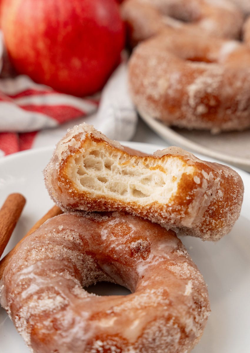 glazed apple cider donuts on a white plate