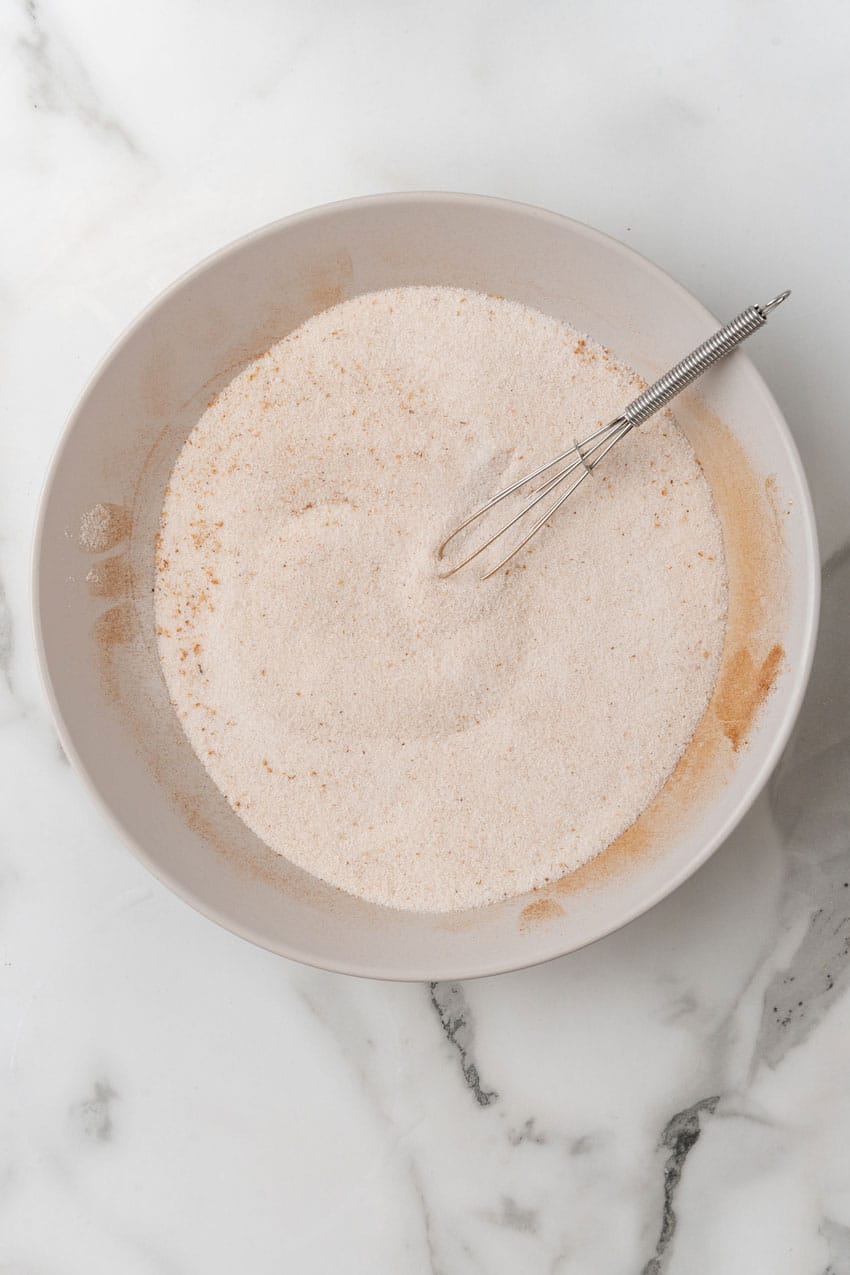 cinnamon sugar mixture in a white mixing bowl