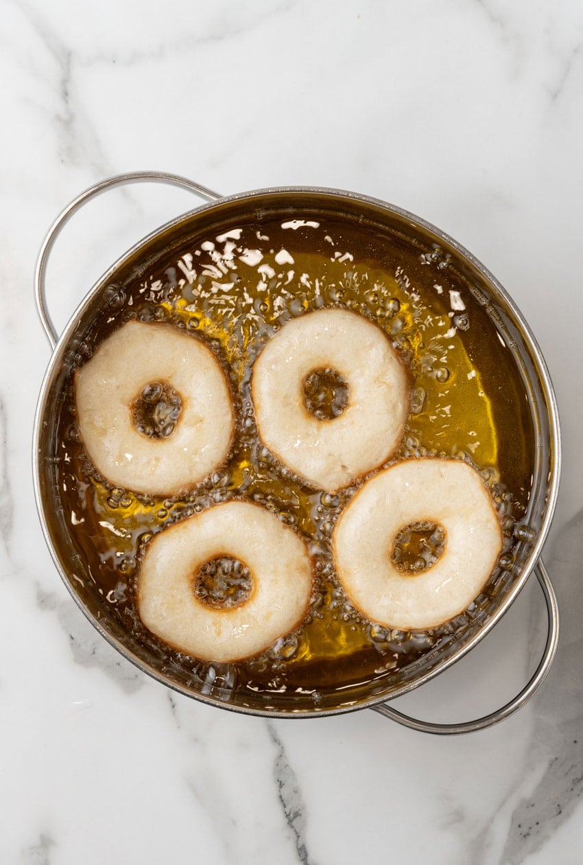 donuts frying in a pot of hot oil