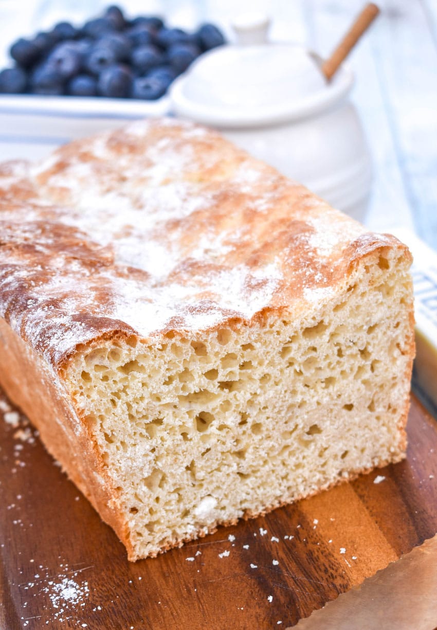 a loaf of english muffin bread on a wooden cutting board