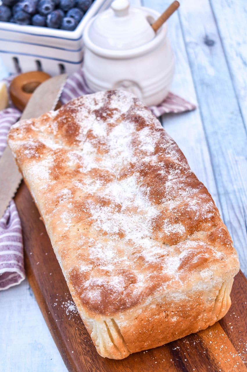 a loaf of english muffin bread on a wooden cutting board