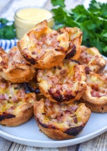 monte cristo puff pastry bites stacked on a white plate