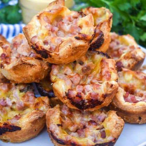 monte cristo puff pastry bites stacked on a white plate