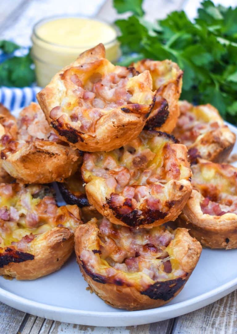 monte cristo puff pastry bites stacked on a white plate
