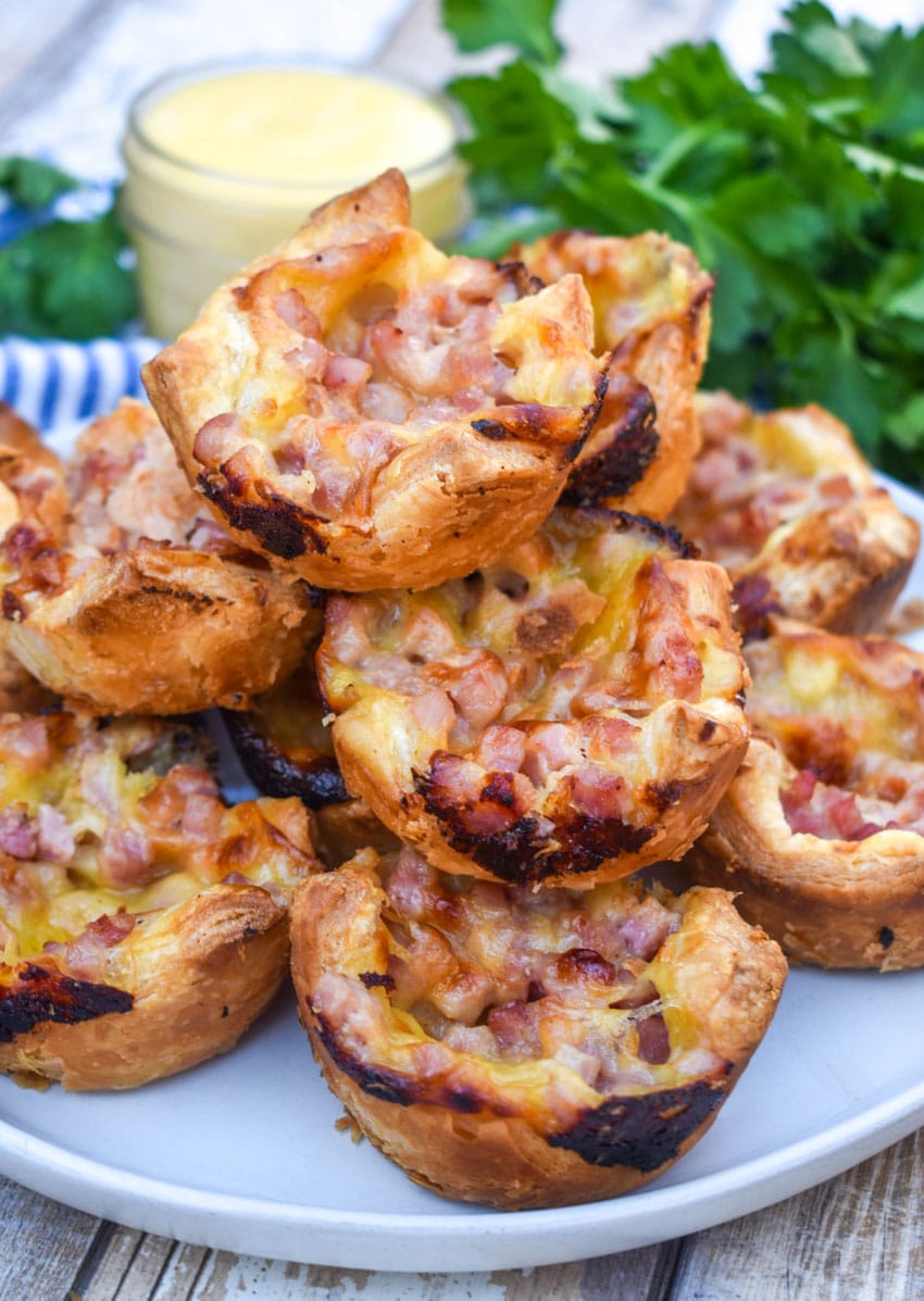monte cristo puff pastry bites stacked on a white plate