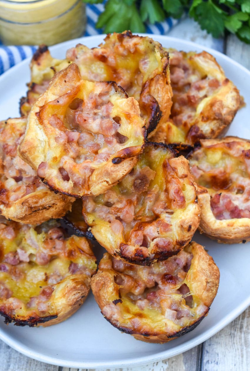 monte cristo puff pastry bites stacked on a white plate